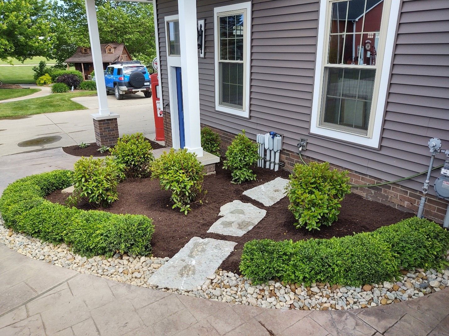 A house with a lush green garden in front of it