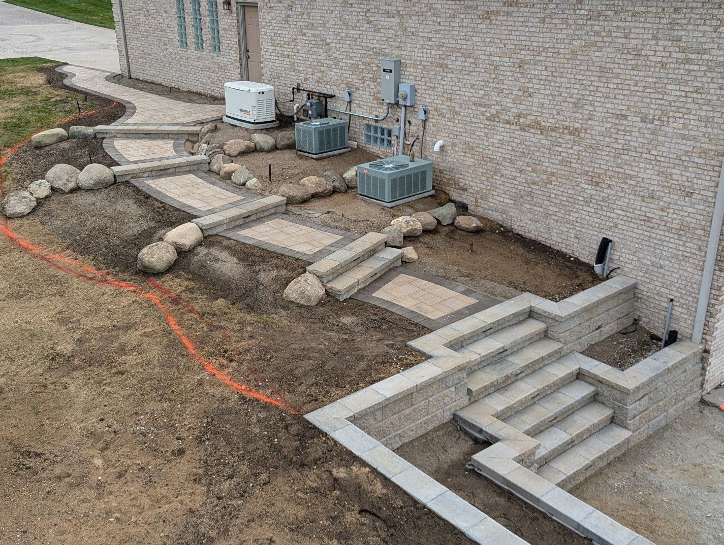 A brick building with stairs and a walkway in front of it.