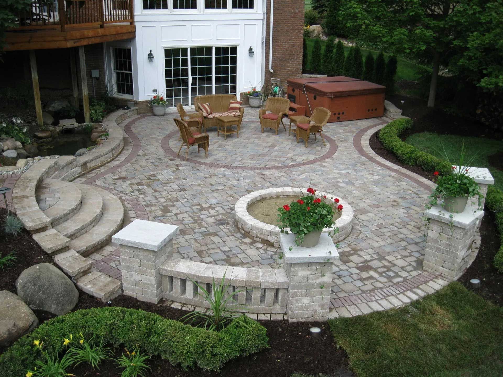 A patio with a fire pit in the middle of it