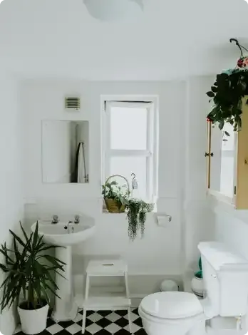 A modern bathroom featuring a freestanding tub and a glass-enclosed shower with bold, black-and-white marble-style tiling.