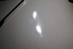 A close up of a white surface with two spots on it.