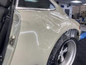 A close up of a car with a protective film on it.