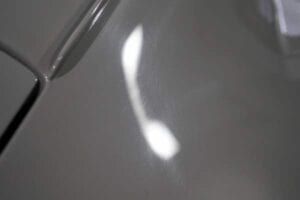 A shadow of a phone is cast on a white surface.