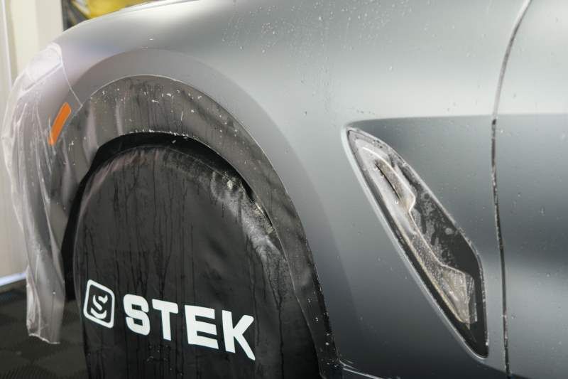 A close up of a car with a tire cover on it.