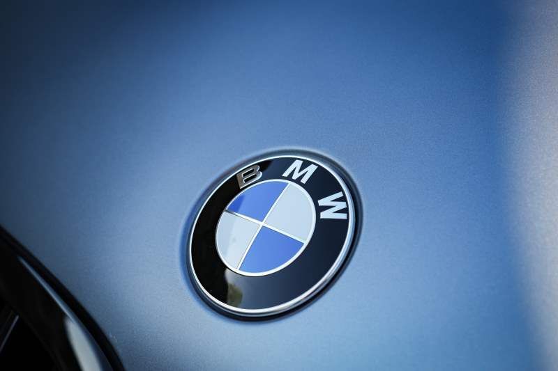A close up of a bmw logo on the side of a car