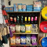 A shelf filled with lots of bags of food and bowls.