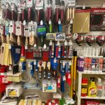 A display of paint brushes and other tools in a store