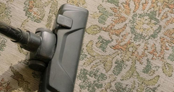 Vacuum cleaner head cleaning a patterned carpet.