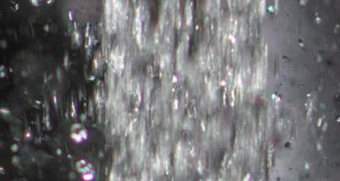 Bubbling water rushing downward; close-up shot.