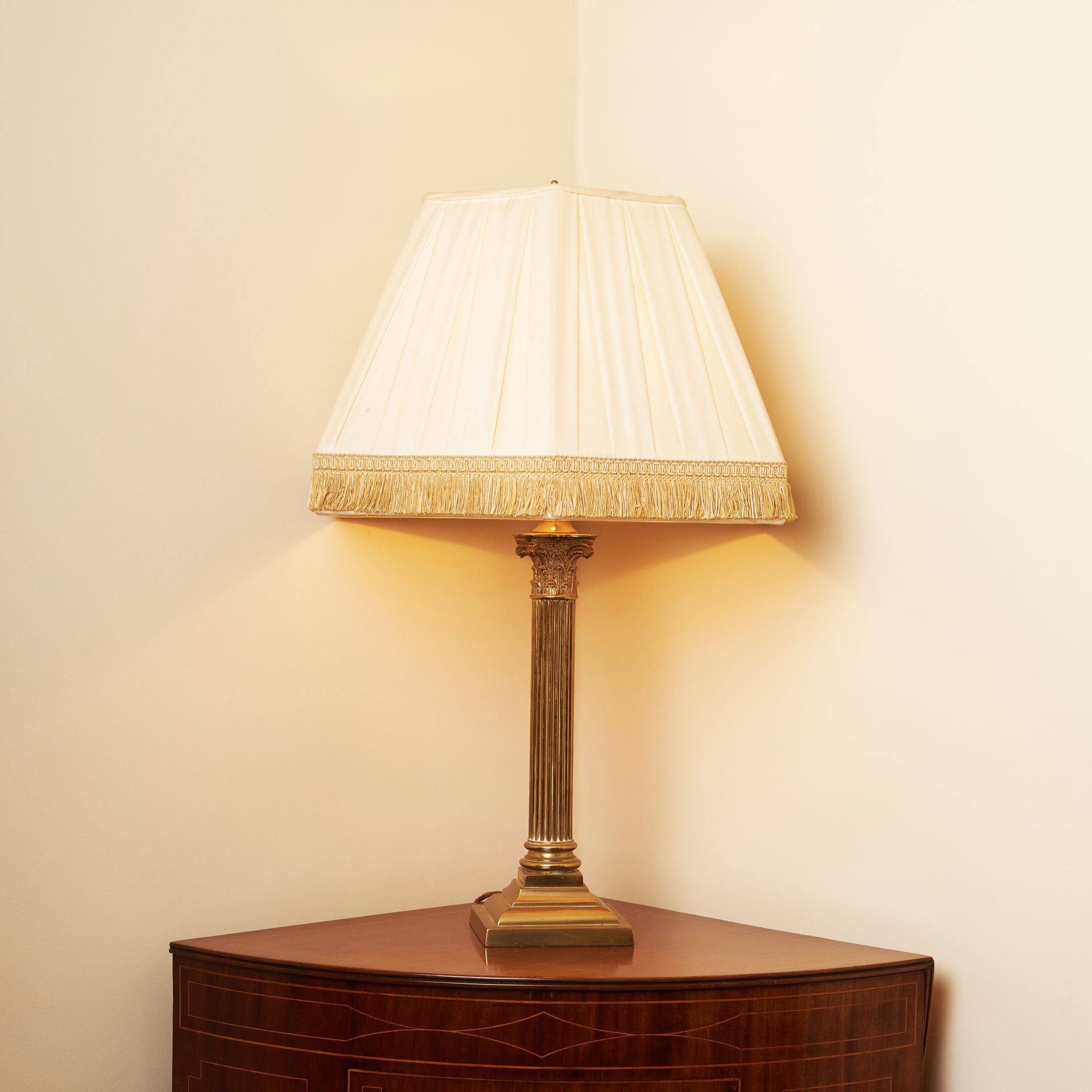 A vintage brass lamp with a Corinthian column base.