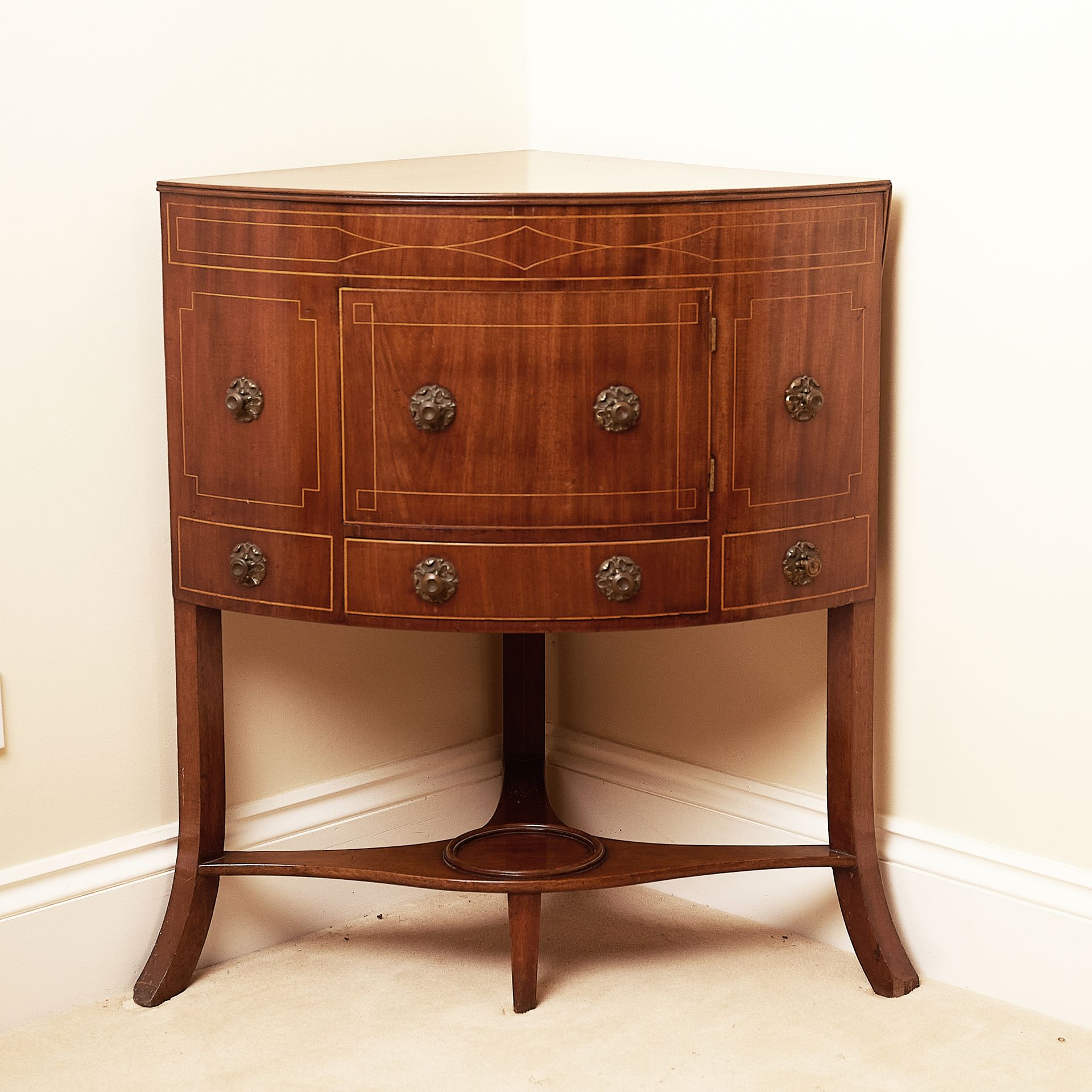 Wooden wash stand or corner table with elegant inlay on the cupboard door.