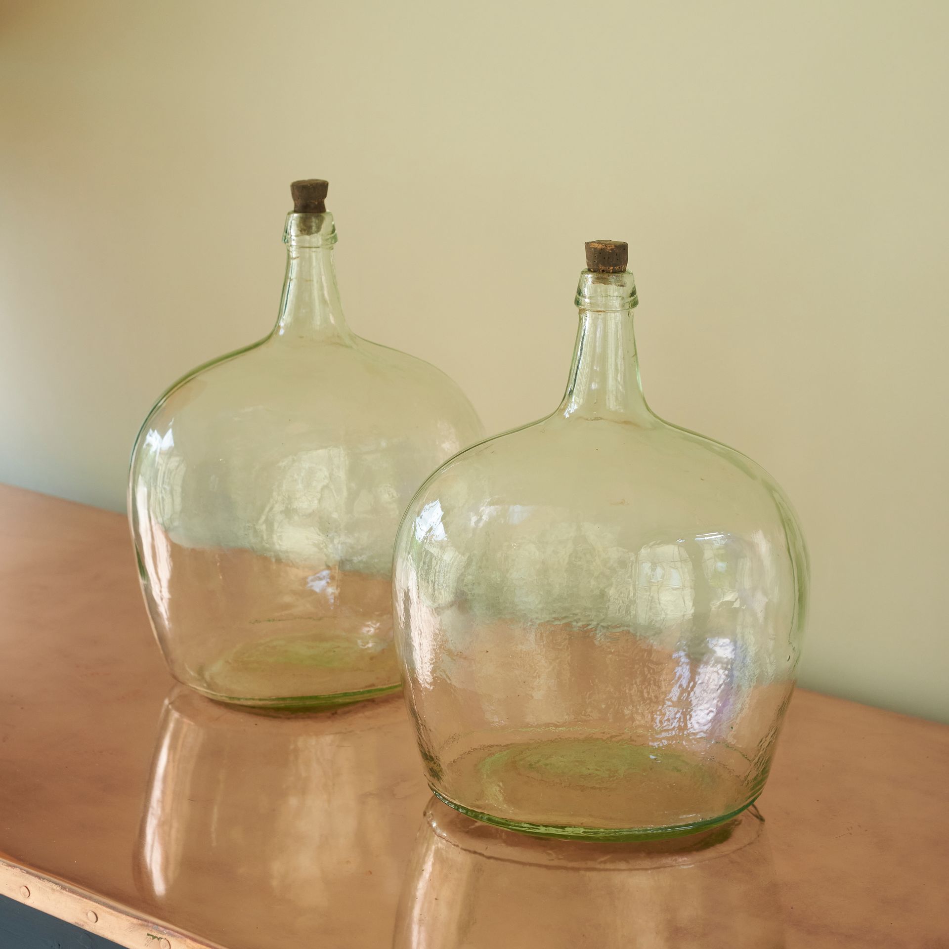 2 glass brandy bottles with unusual ovular bodies and short, slender necks. 