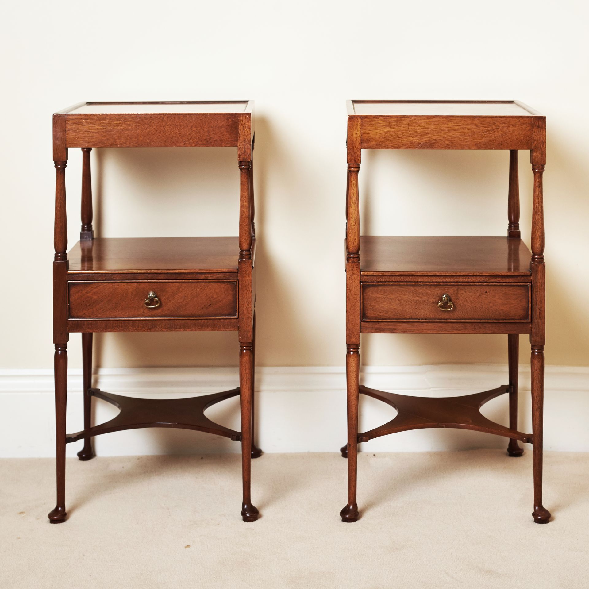 A set of bedside tables with turned feet, small drawers, and 2 shelves.