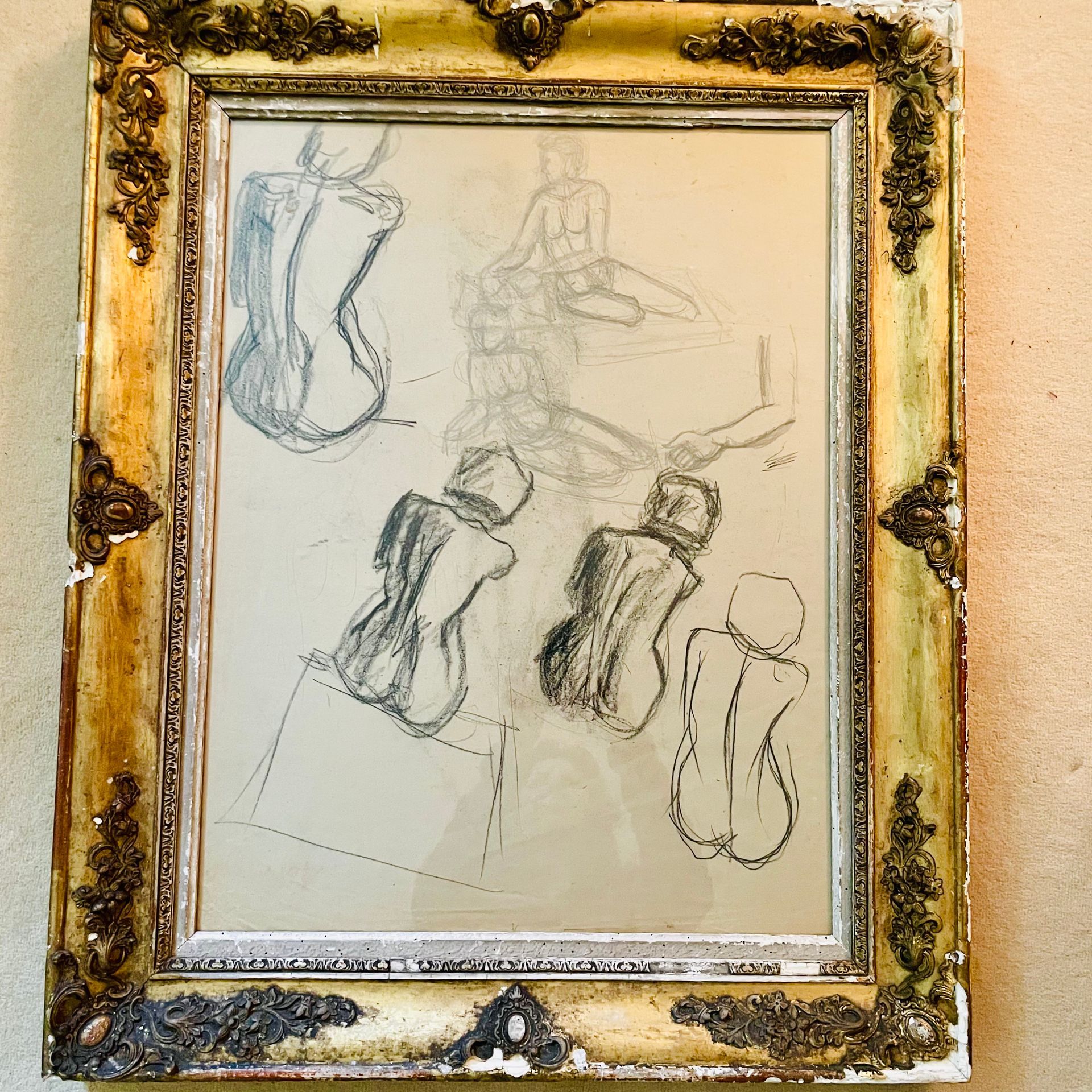 Charcoal sketches and studies of a nude female model in a gilt stucco frame.
