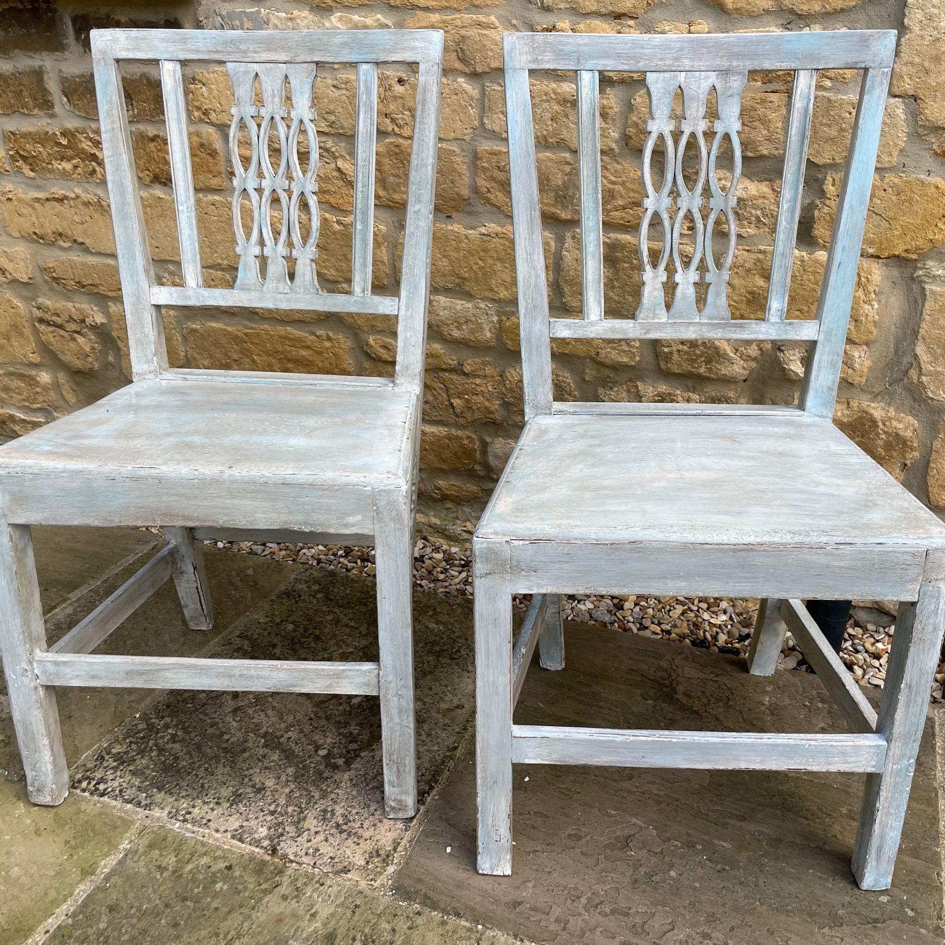 2 oak chairs with a decorative back, rustically painted in a blue/grey.
