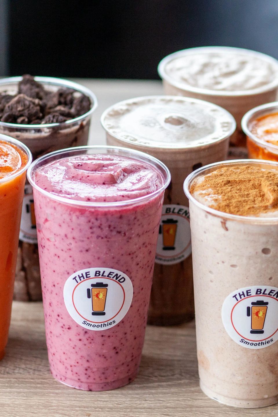 Colorful smoothies in clear cups, branded with
