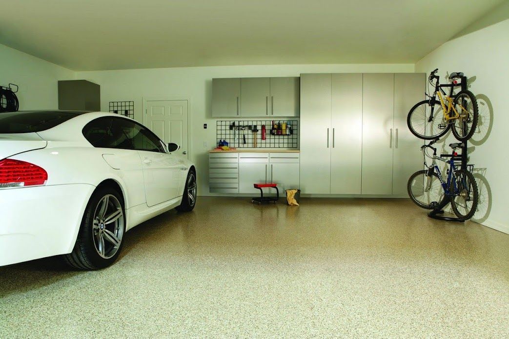 An empty garage with a garage door open and a garage door opener.