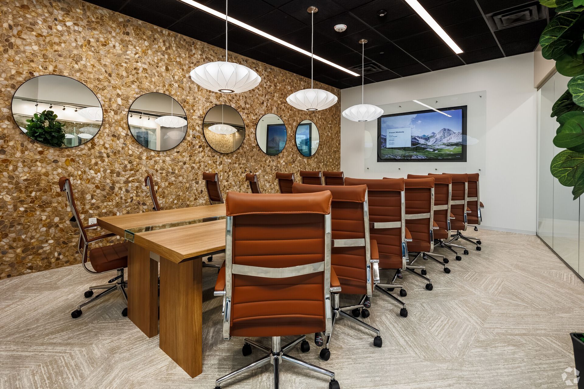 A conference room with a long table and chairs.