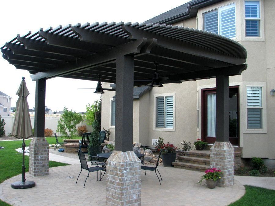 A pergola with a table and chairs underneath it