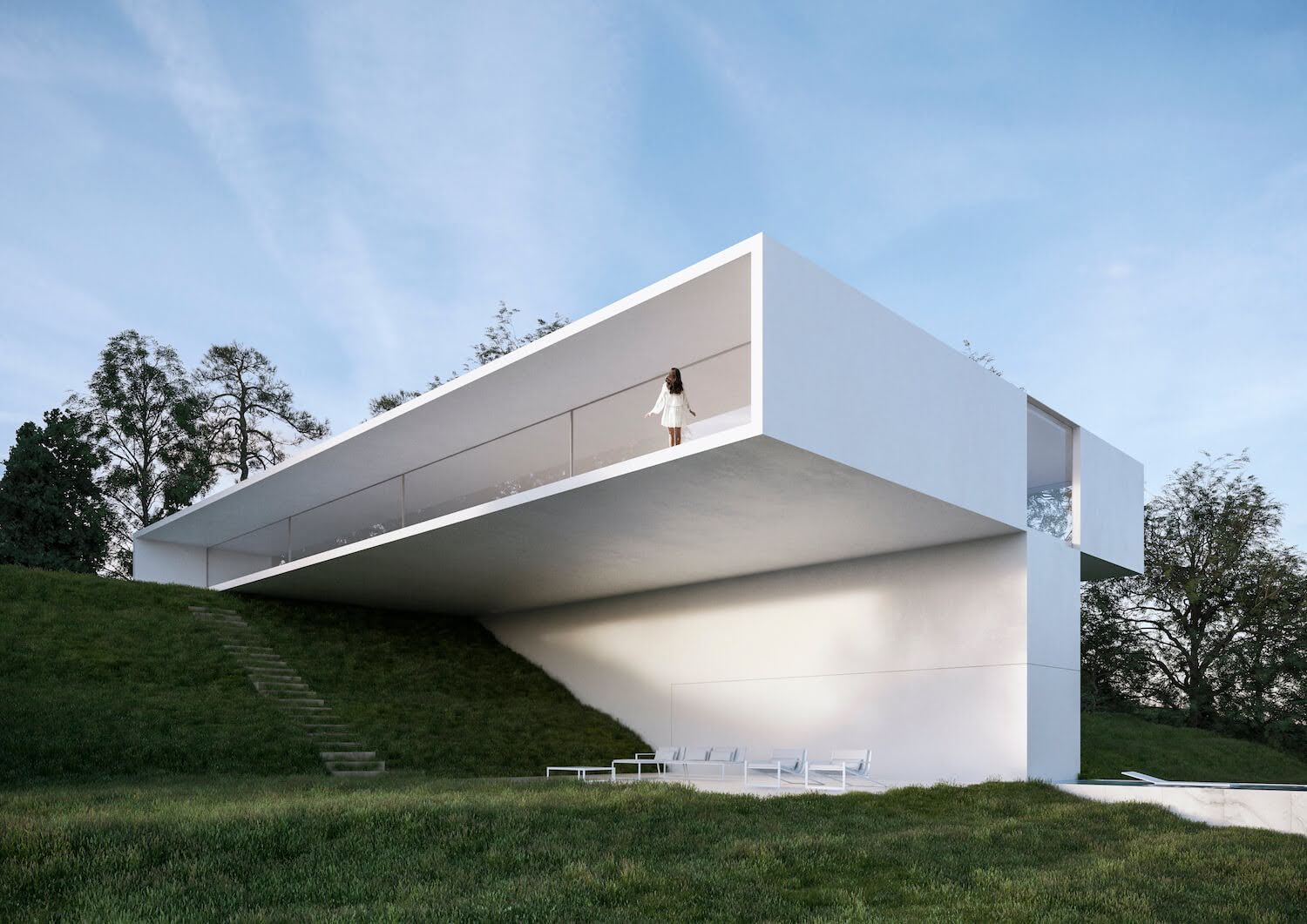 White modern house with a large cantilevered overhang on a grassy hill; person on balcony.