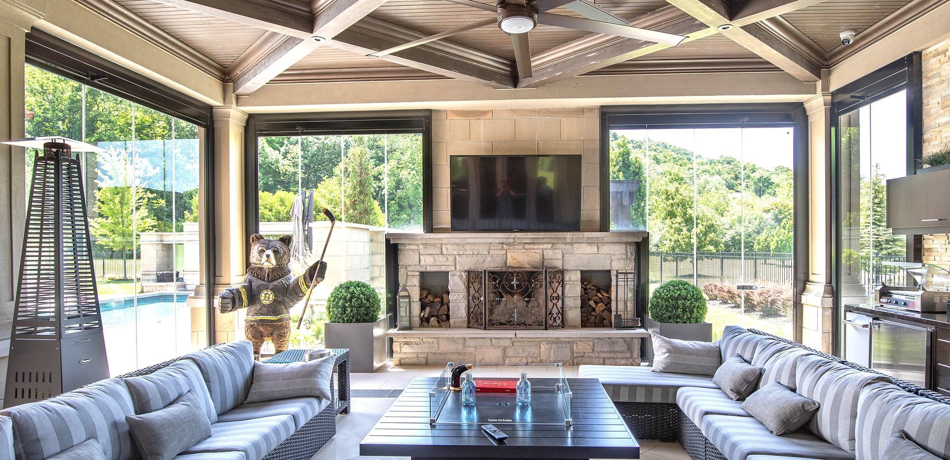 There is a large table in the middle of the room with lots of windows.