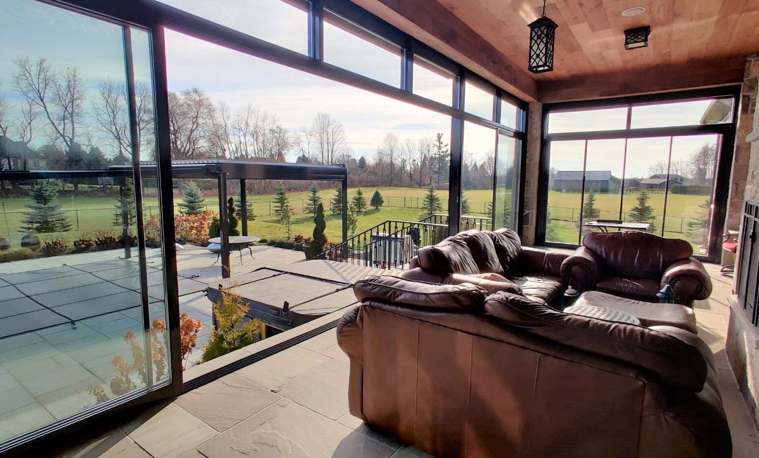 A living room with a lot of windows and a couch.
