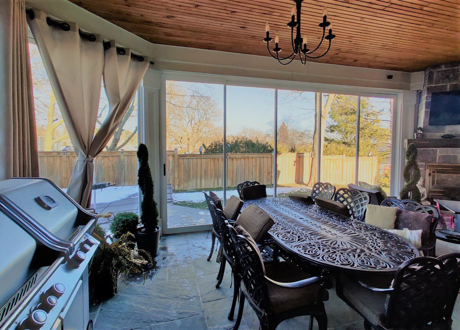 A dining room with a table and chairs and a grill