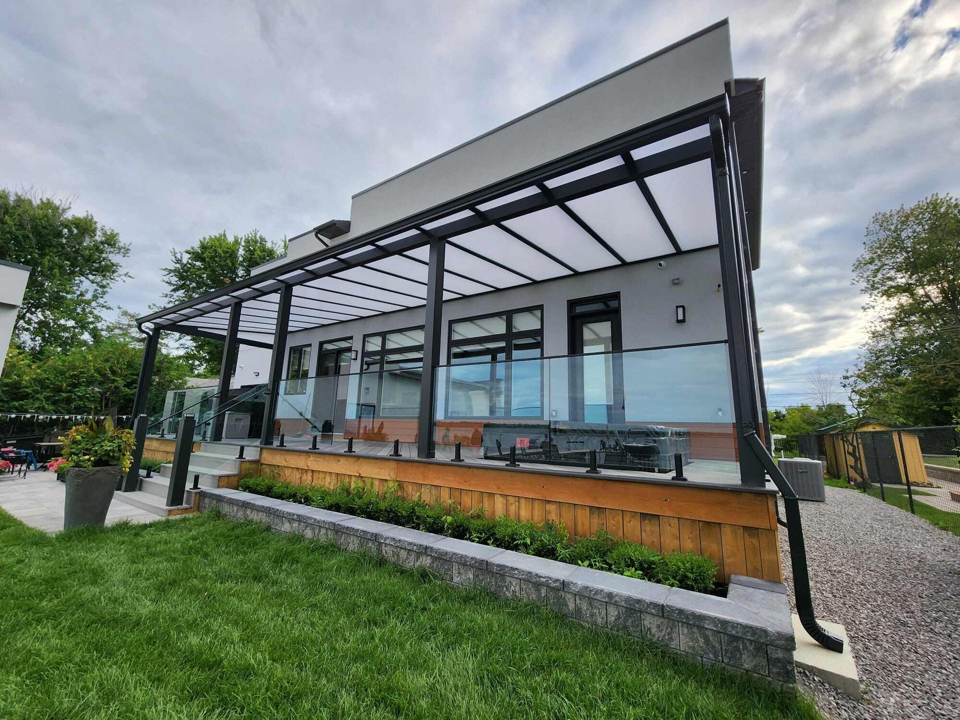 A large house with a pergola on the side of it.