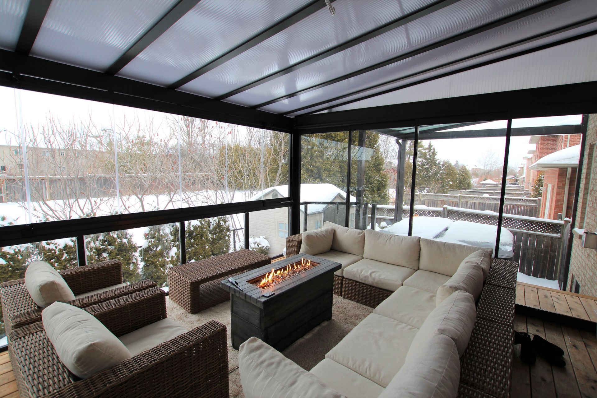 A living room with a couch and chairs and a fire pit