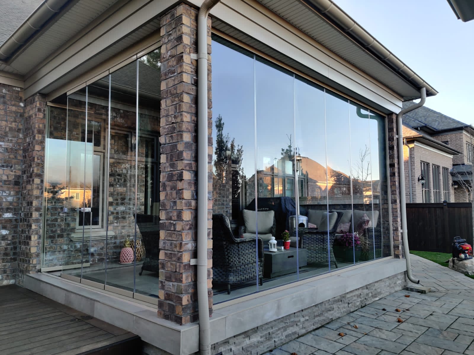 A patio with sliding glass doors and a brick wall.