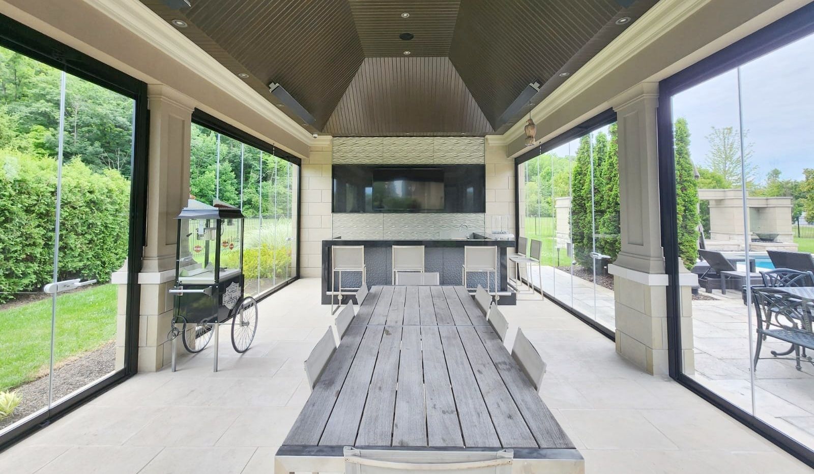 There is a large table in the middle of the room with lots of windows.