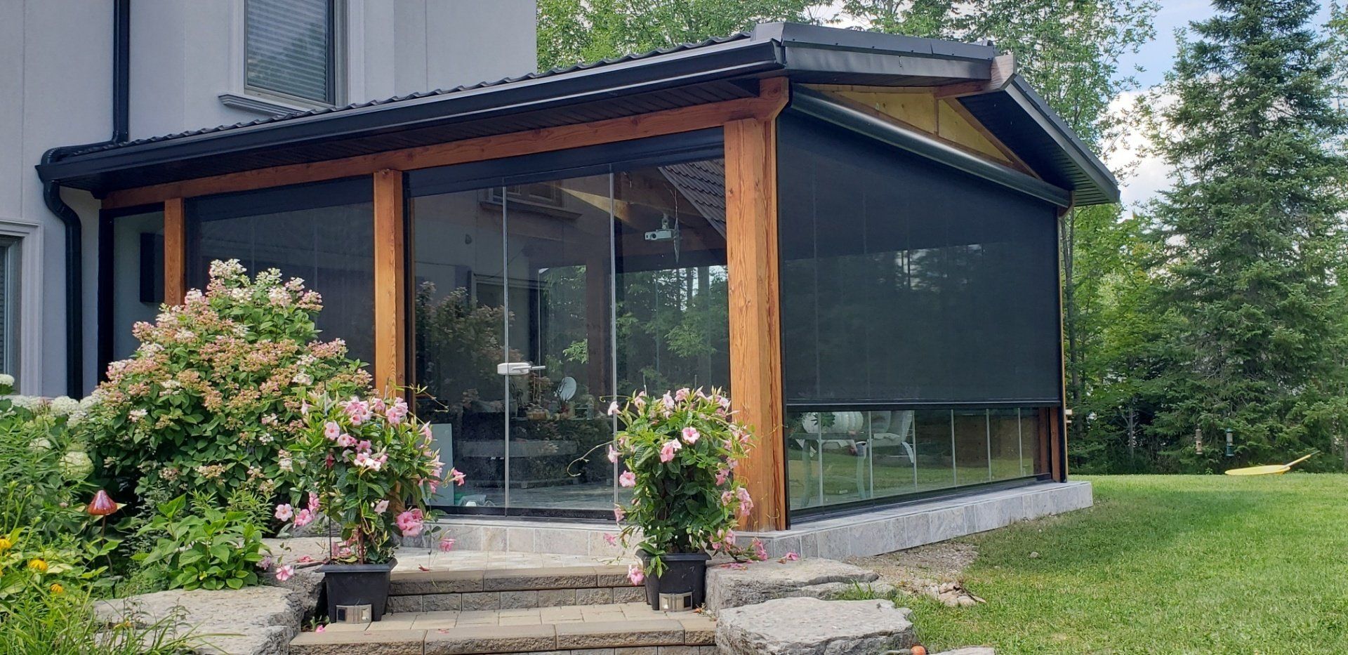 A house with a screened in porch and stairs leading to it.