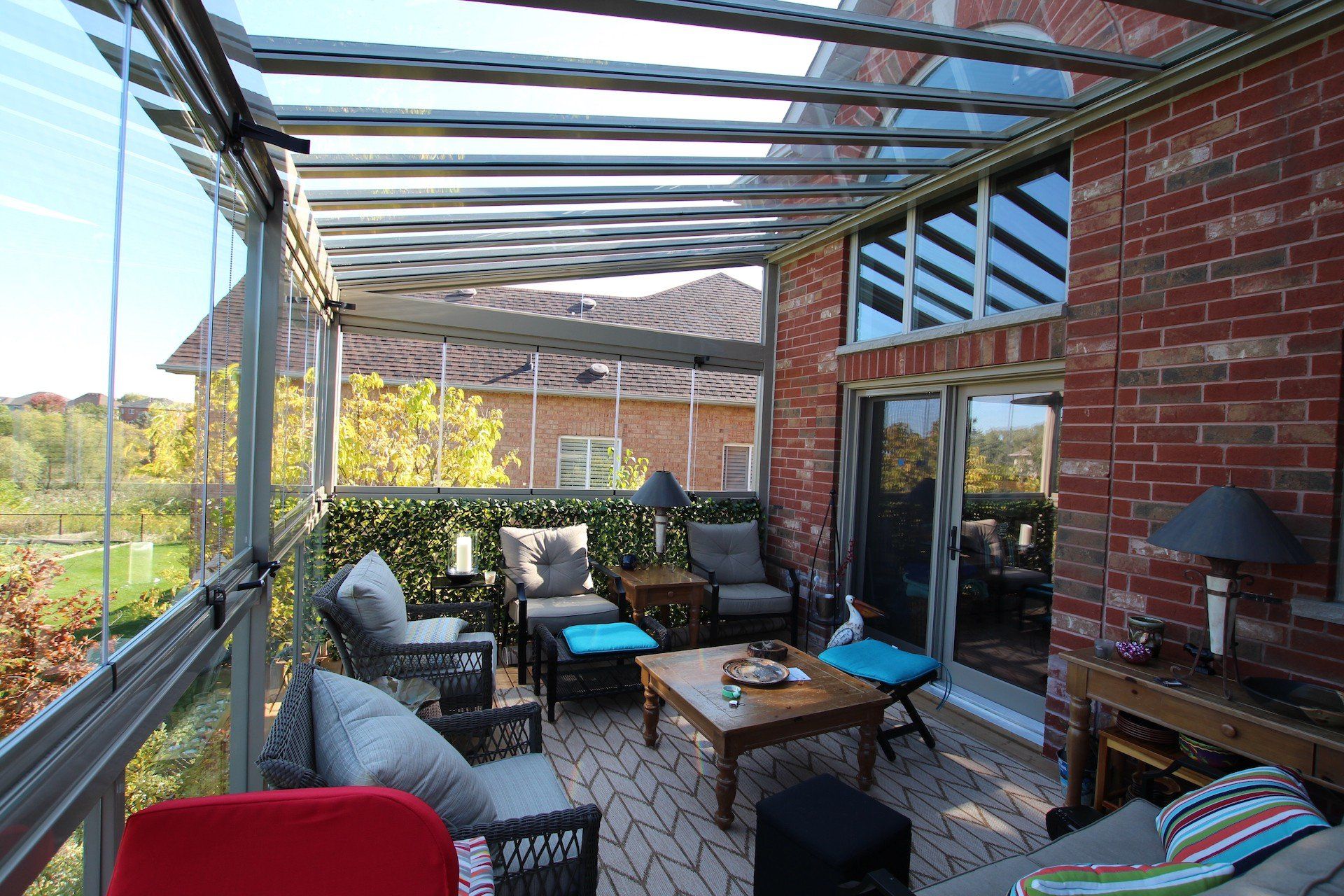 A living room with a couch , table , chairs and a pergola.