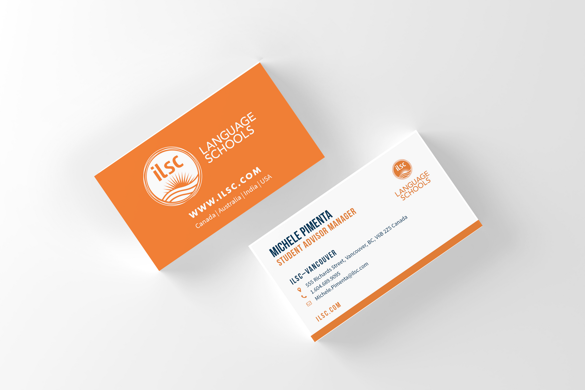 Two orange-and-white business cards with a clean, modern design on a light gray background