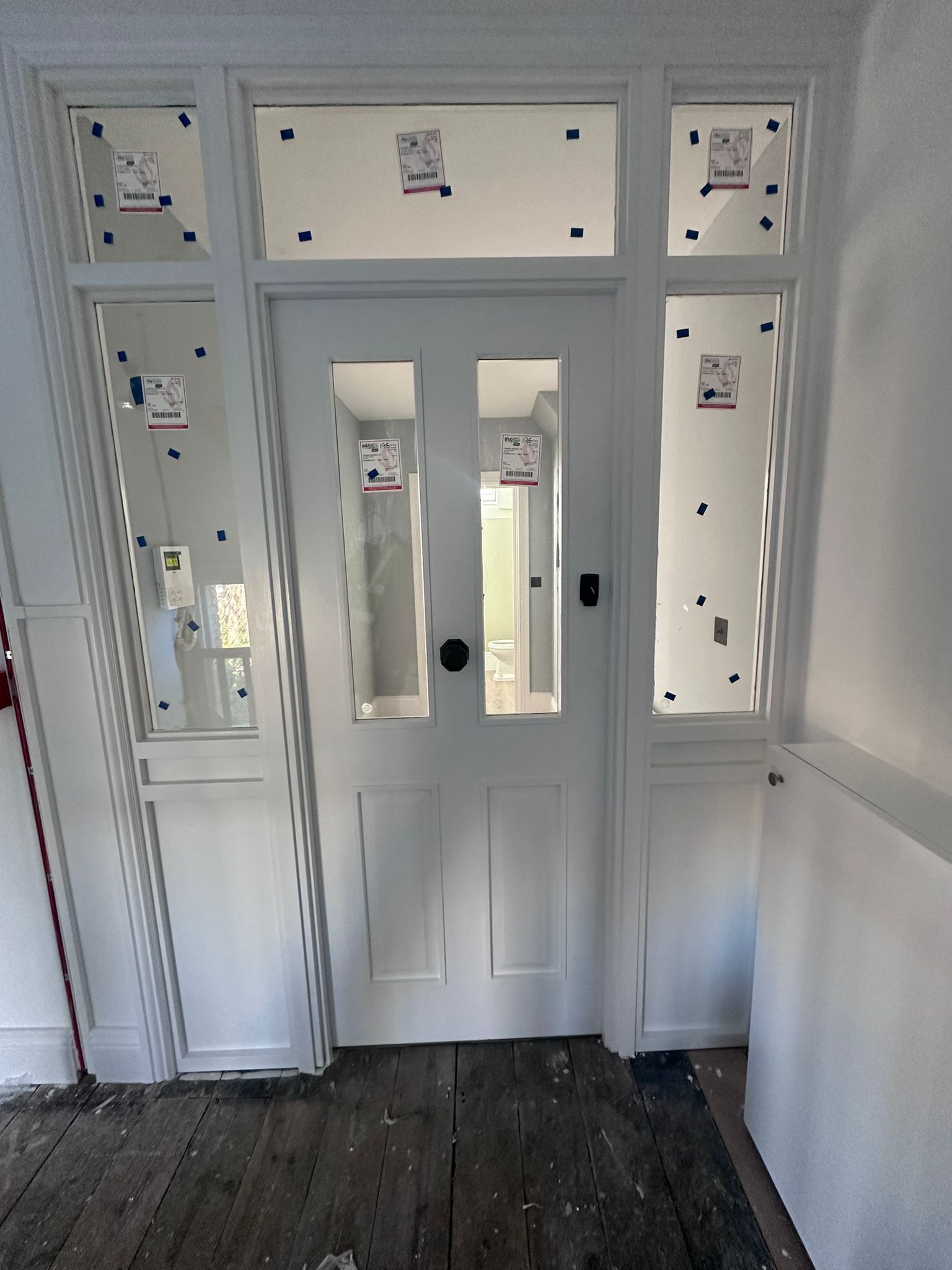 White fire door  with glass panels and sidelights.
