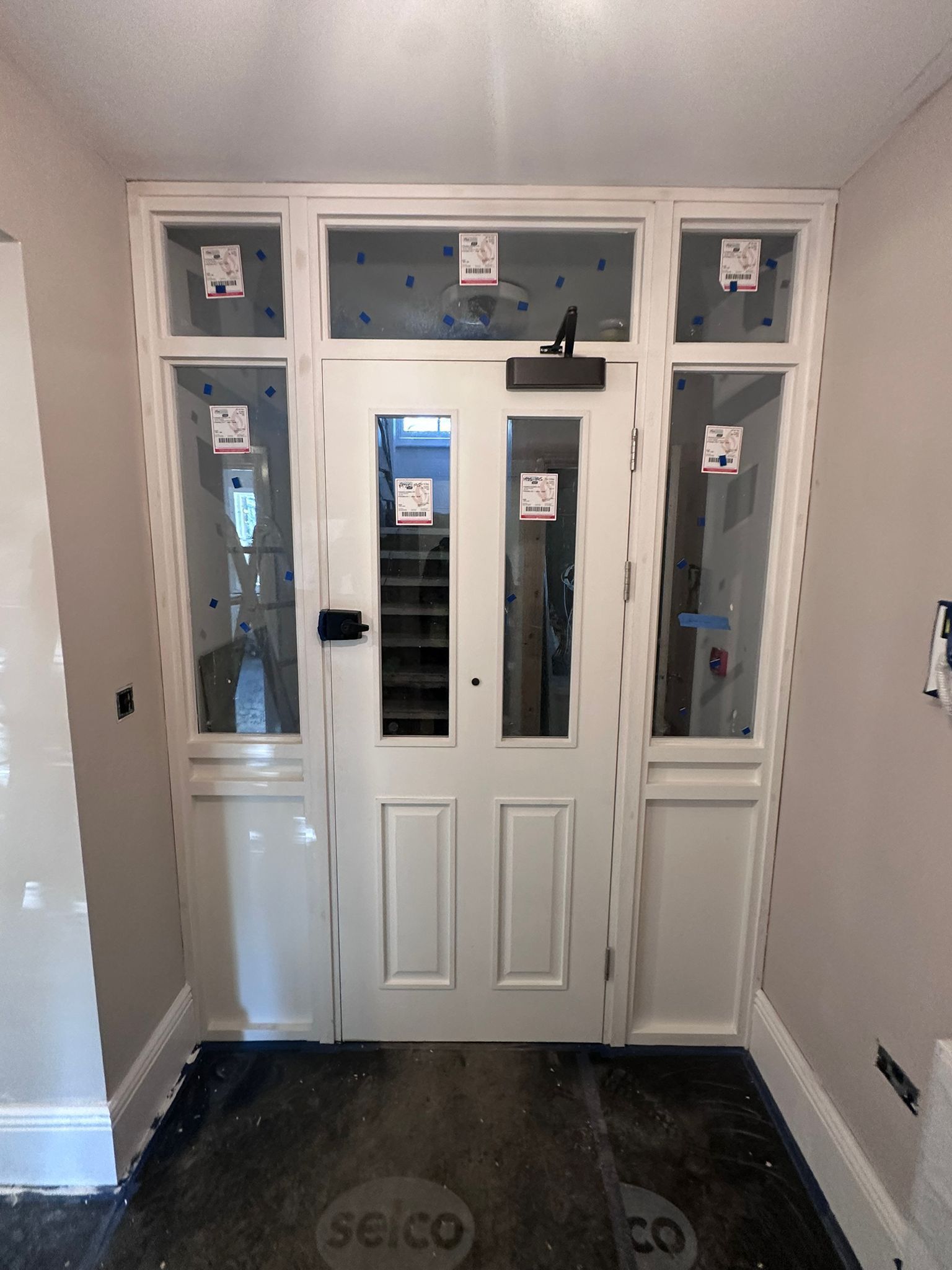 White fire door  with glass panels and sidelights.