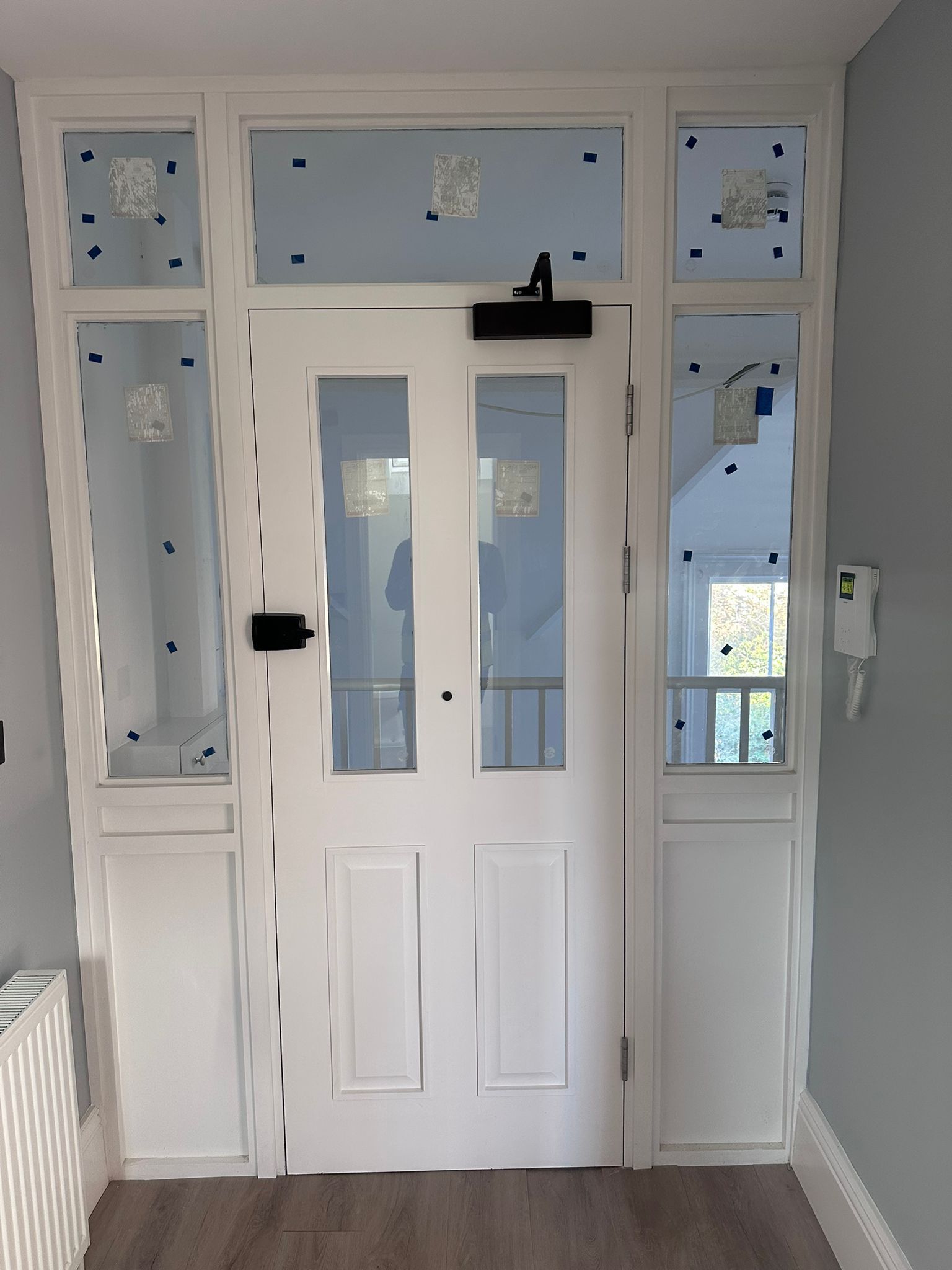 White fire door  with glass panels and sidelights.