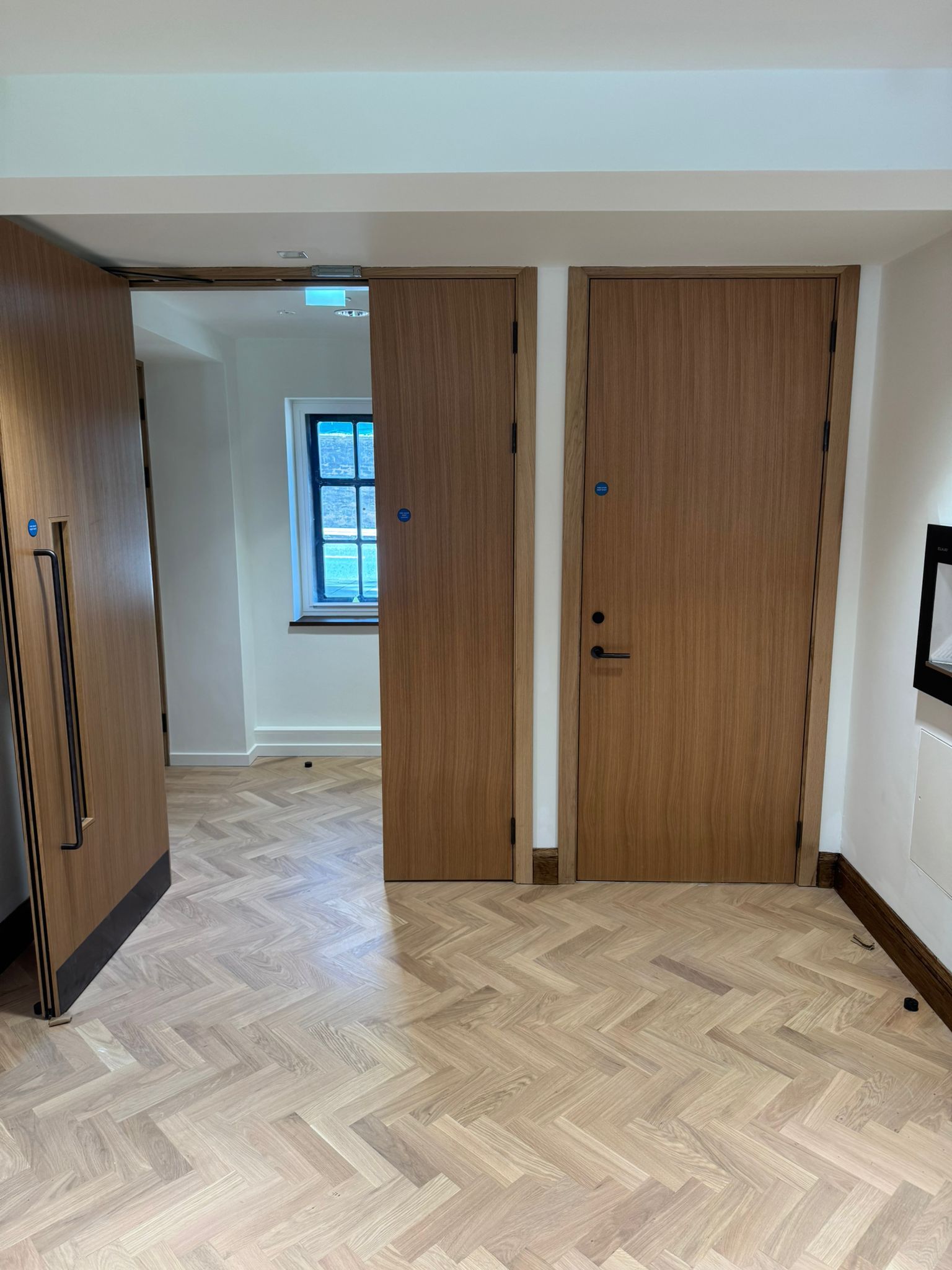Hallway with three fire doors, and an exit sign.