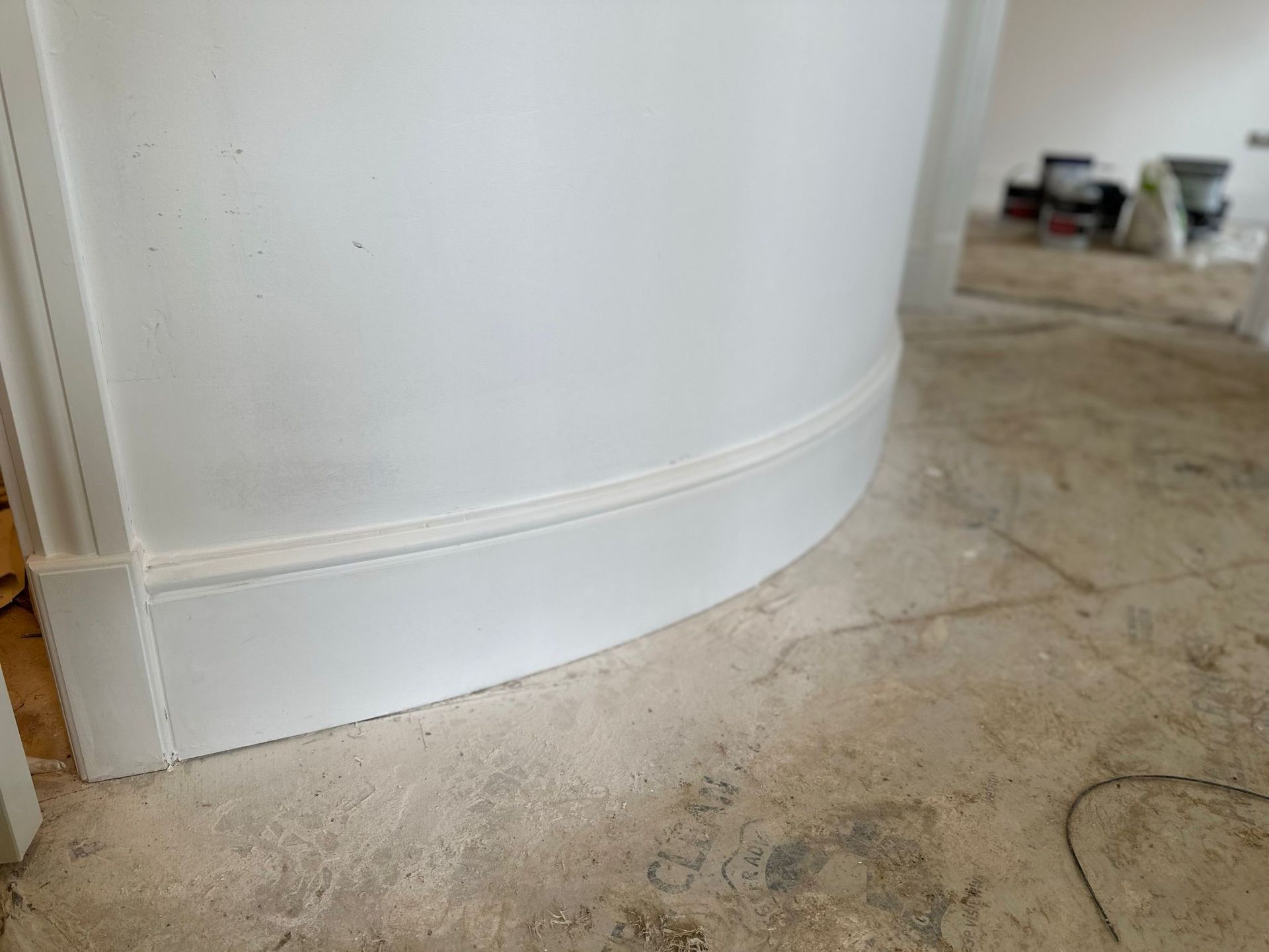 White customized curved wood on a doorway.