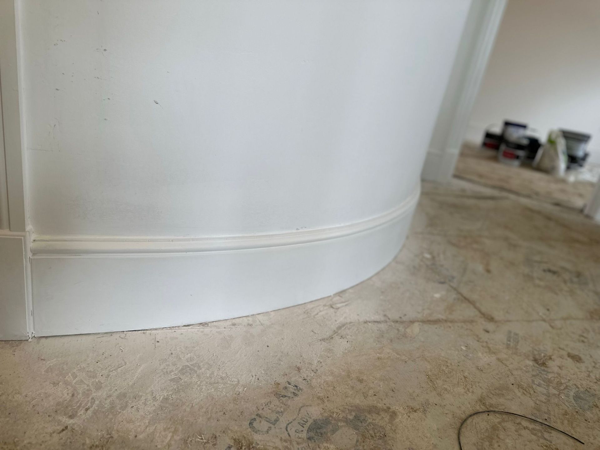 White customized curved wood on a doorway.