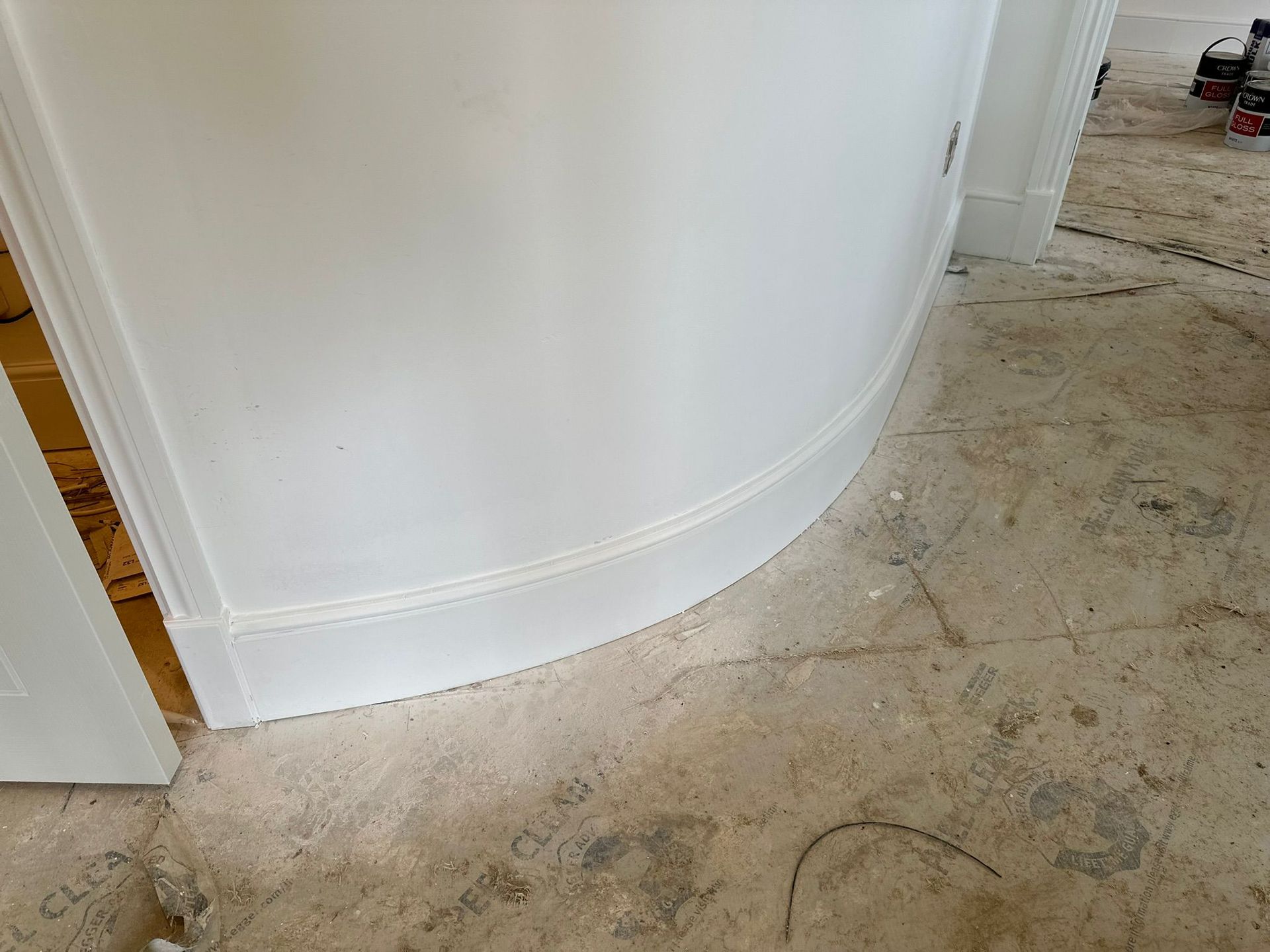 White customized curved wood on a doorway.