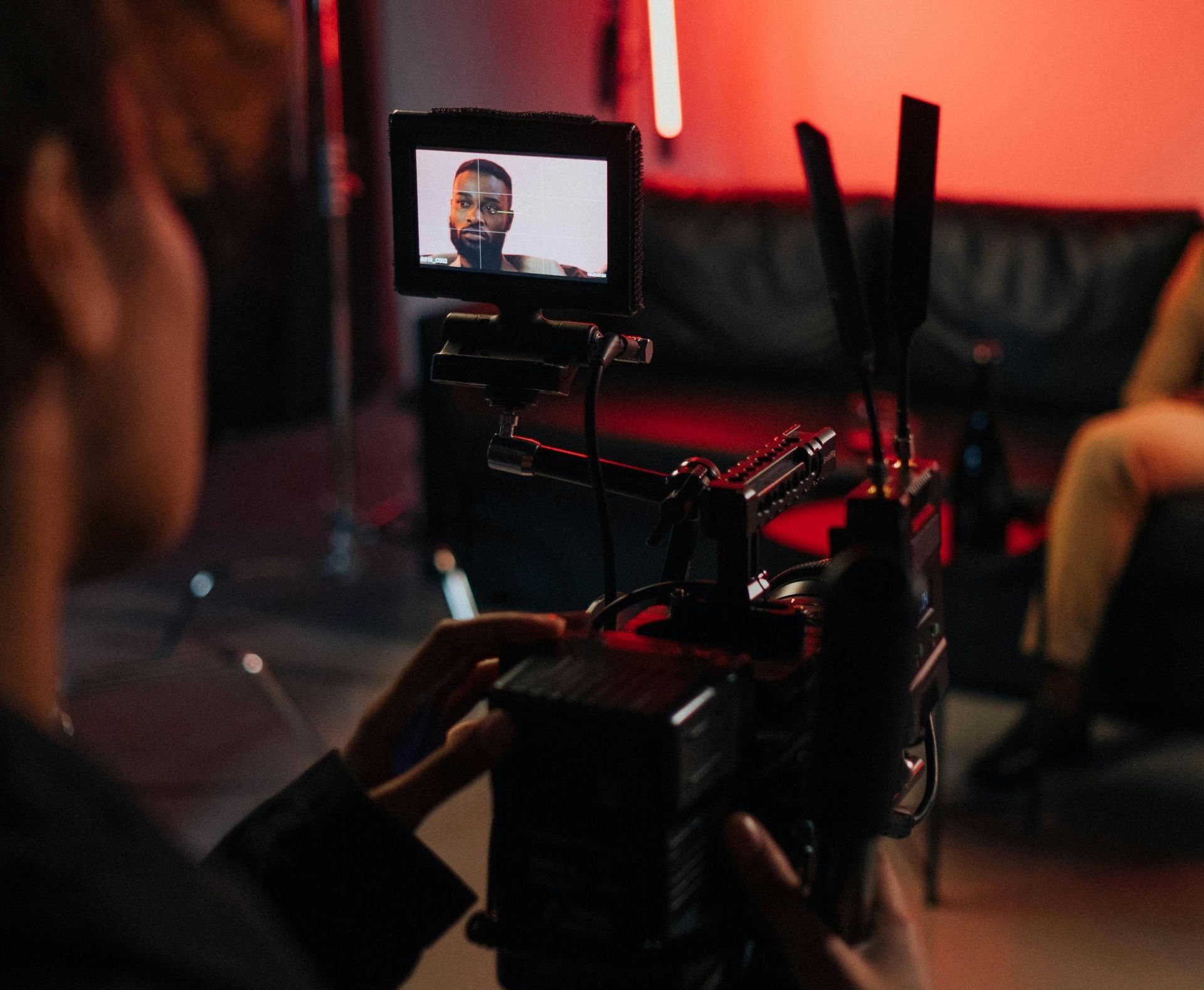 A man is recording a video with a camera.