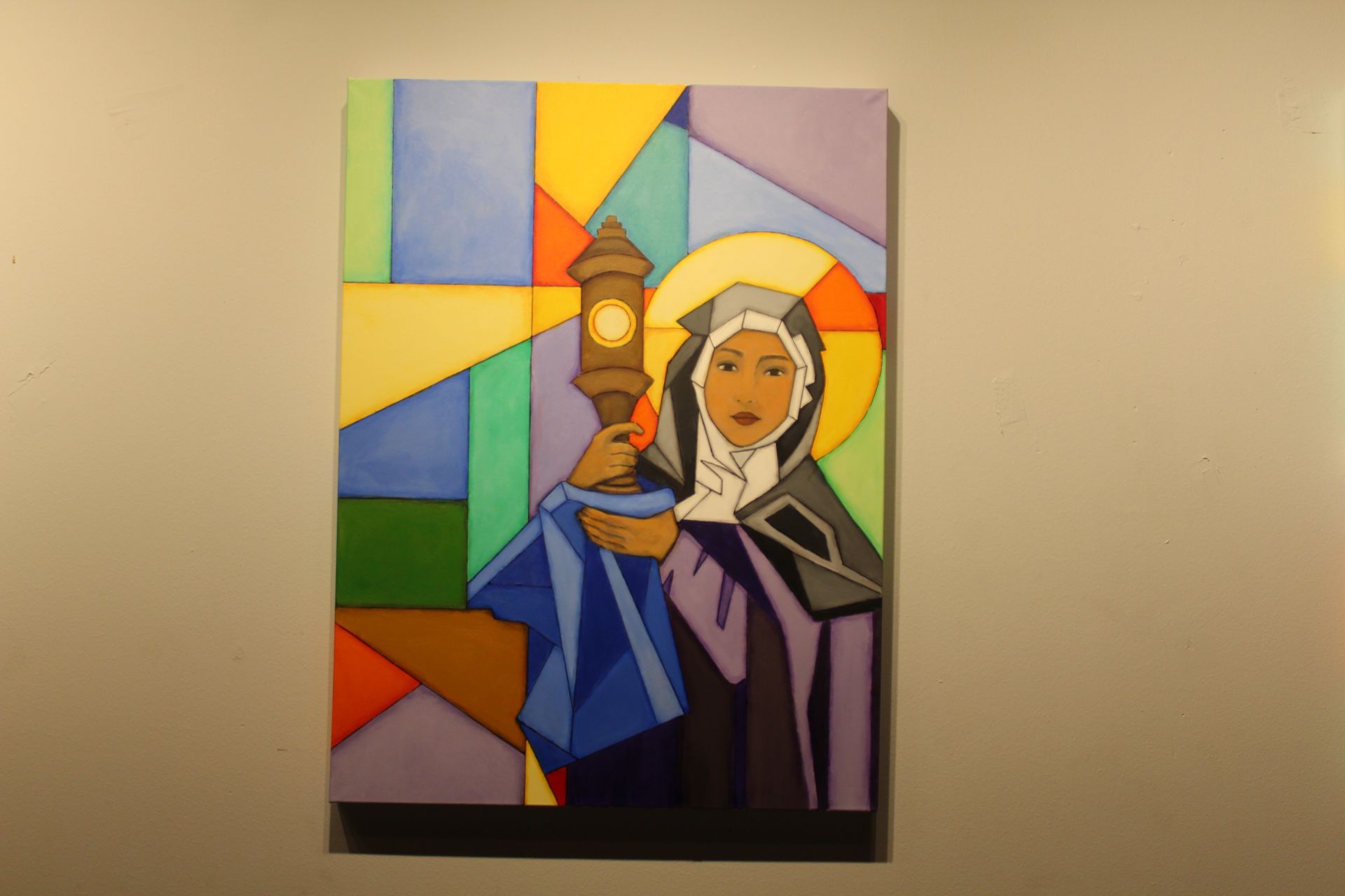 Painting of a woman in a habit holding a lantern, geometric stained-glass style background.