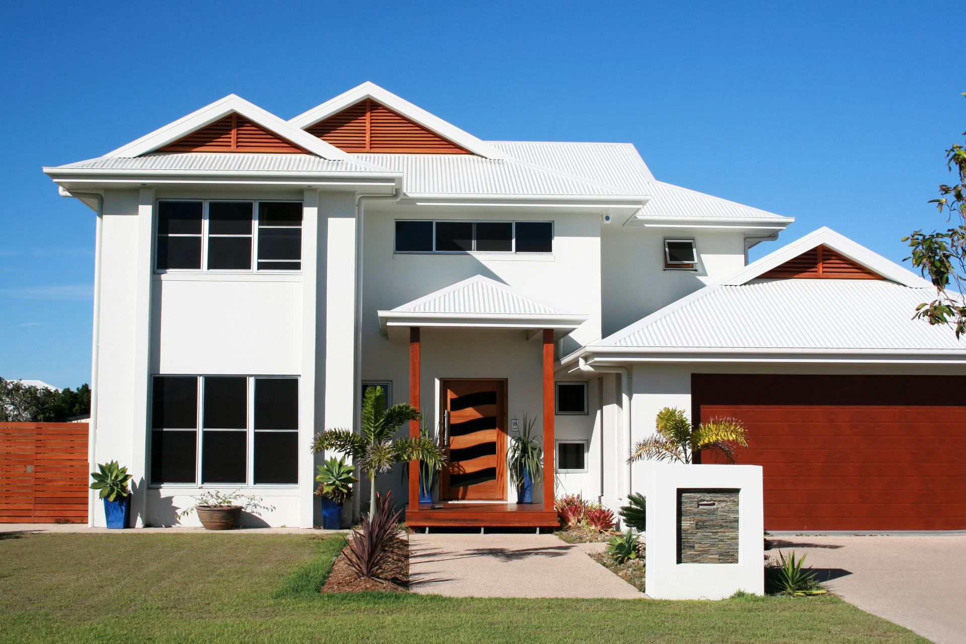 A large white house with a brown garage door