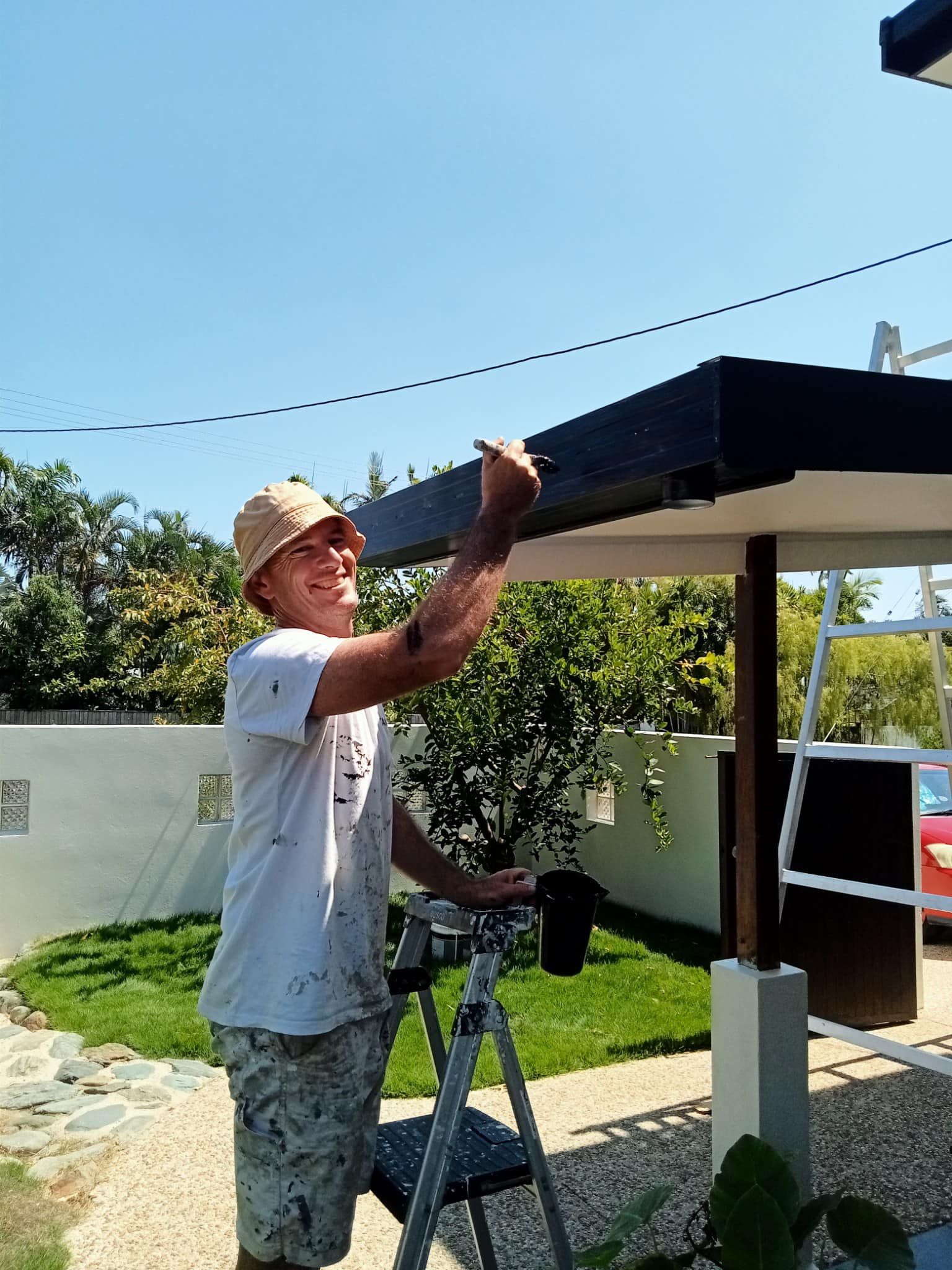 Two Men Are Painting A Wall In A Room — Pete's Painting Solutions In Redlynch, QLD