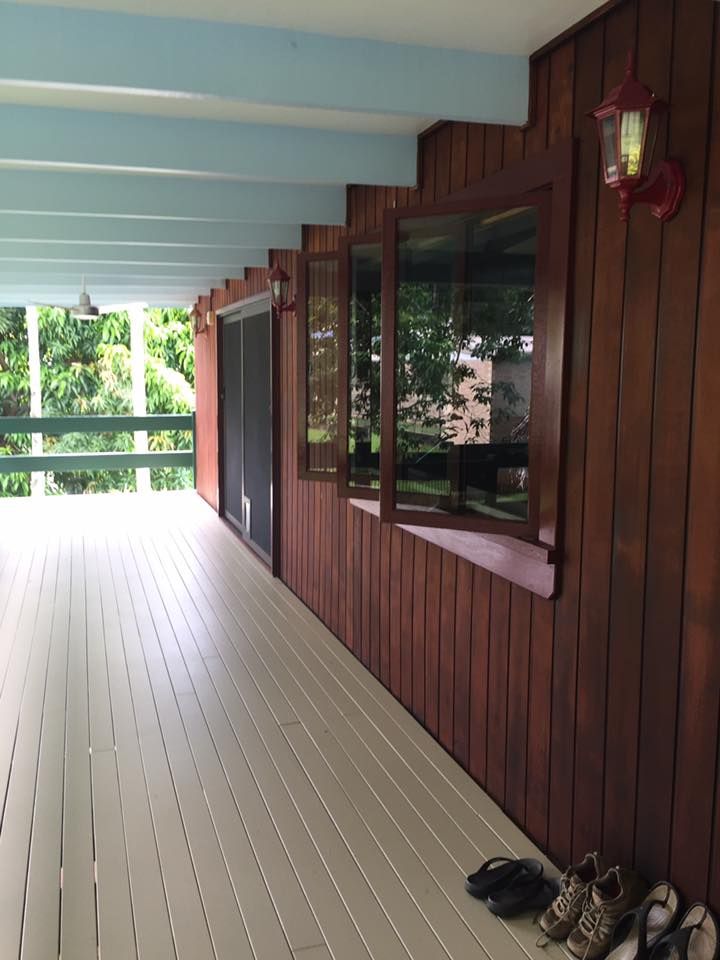 A White Building With A Palm Tree In Front Of It — Pete's Painting Solutions In Kewarra Beach, QLD