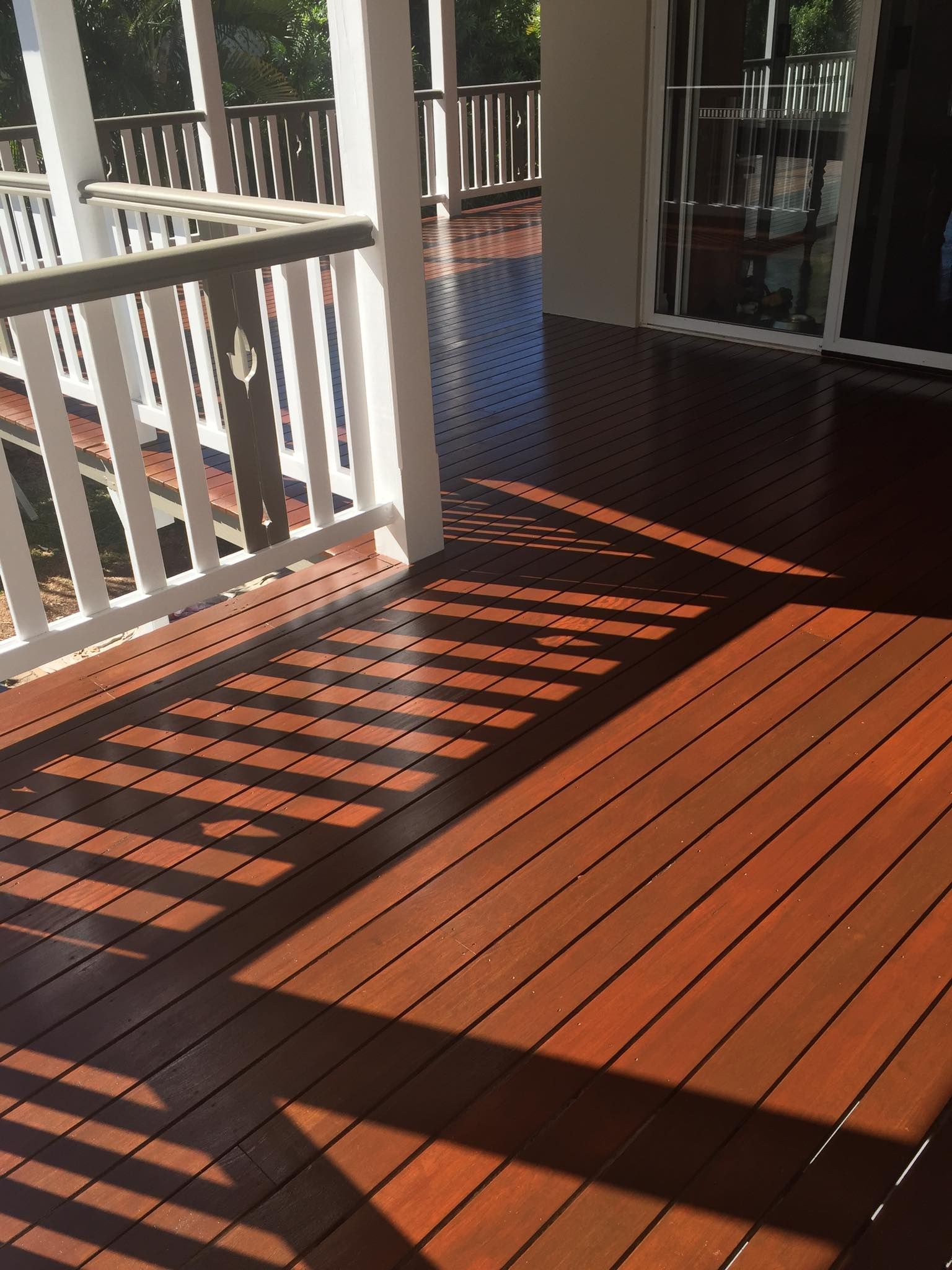 A Man In Orange Pants Is Painting A Yellow Line On The Road — Pete's Painting Solutions In Bungalow, QLD