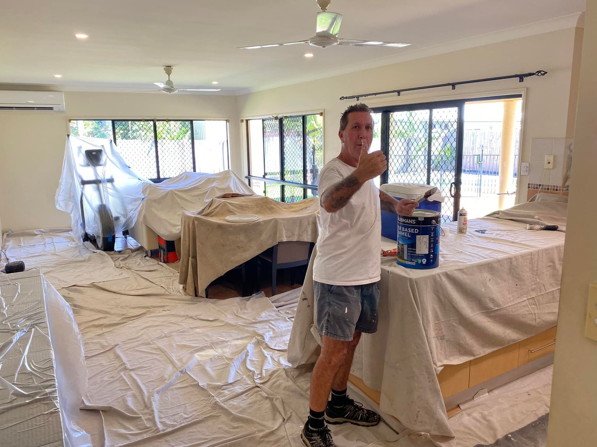 Painter Holding Paintbrush Inside a Room