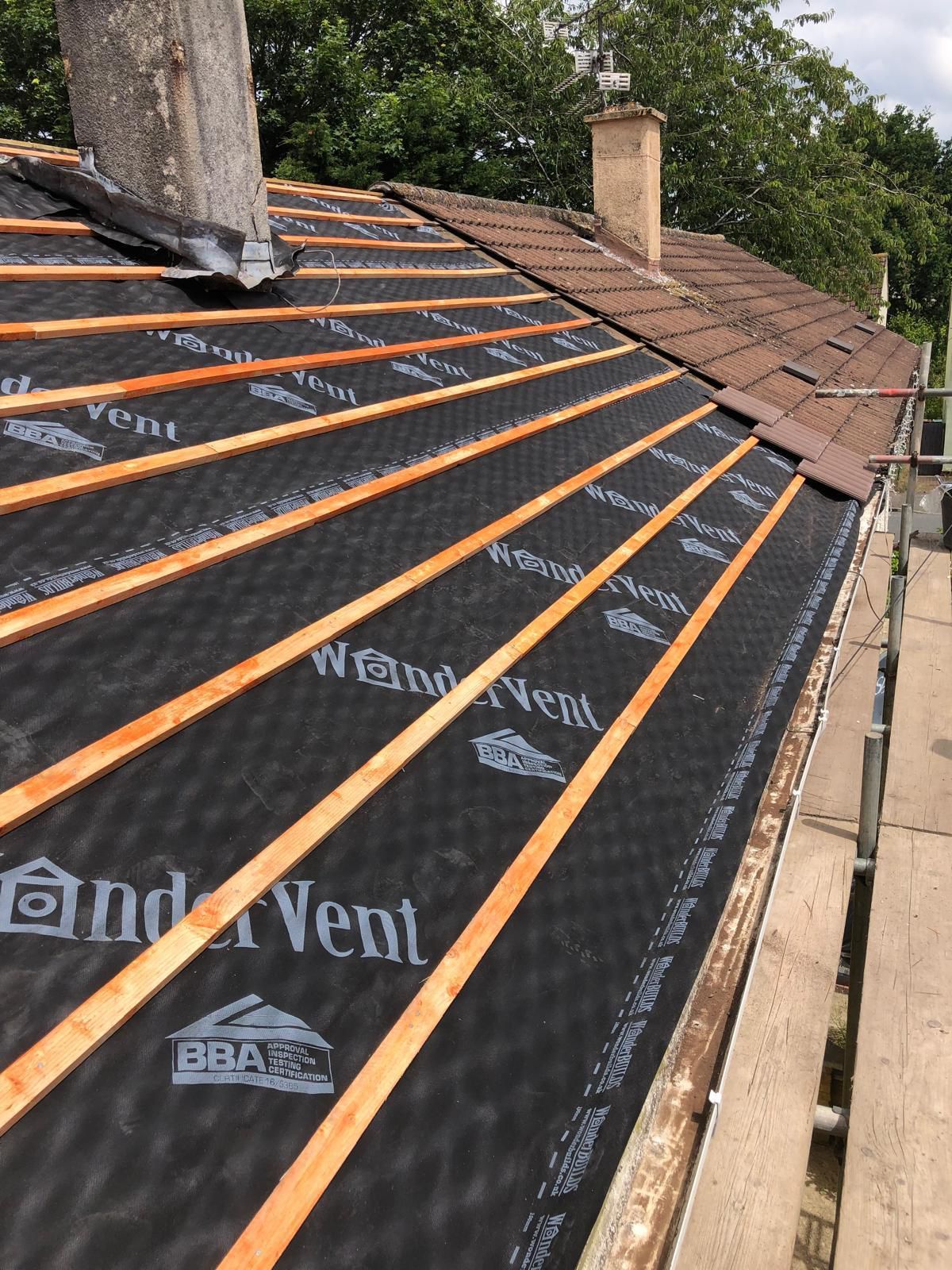 A roof with wooden beams and a chimney on top of it.