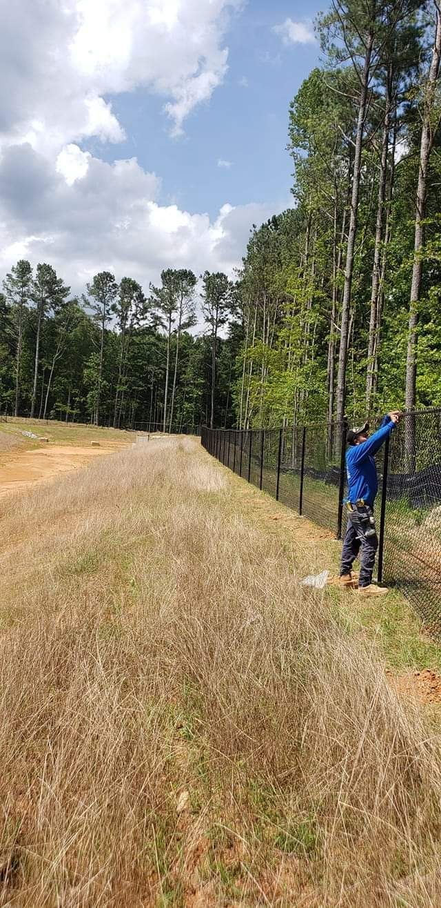 White brick house with dark roof, gutters, and windows against a blue sky.